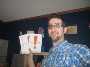 Kevin holding copies of Outspoken.